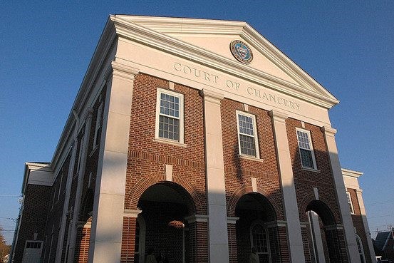 The exterior of a court building that reads, "Court of Chancery."
