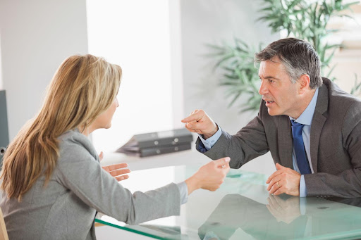 mand and woman arguing in office